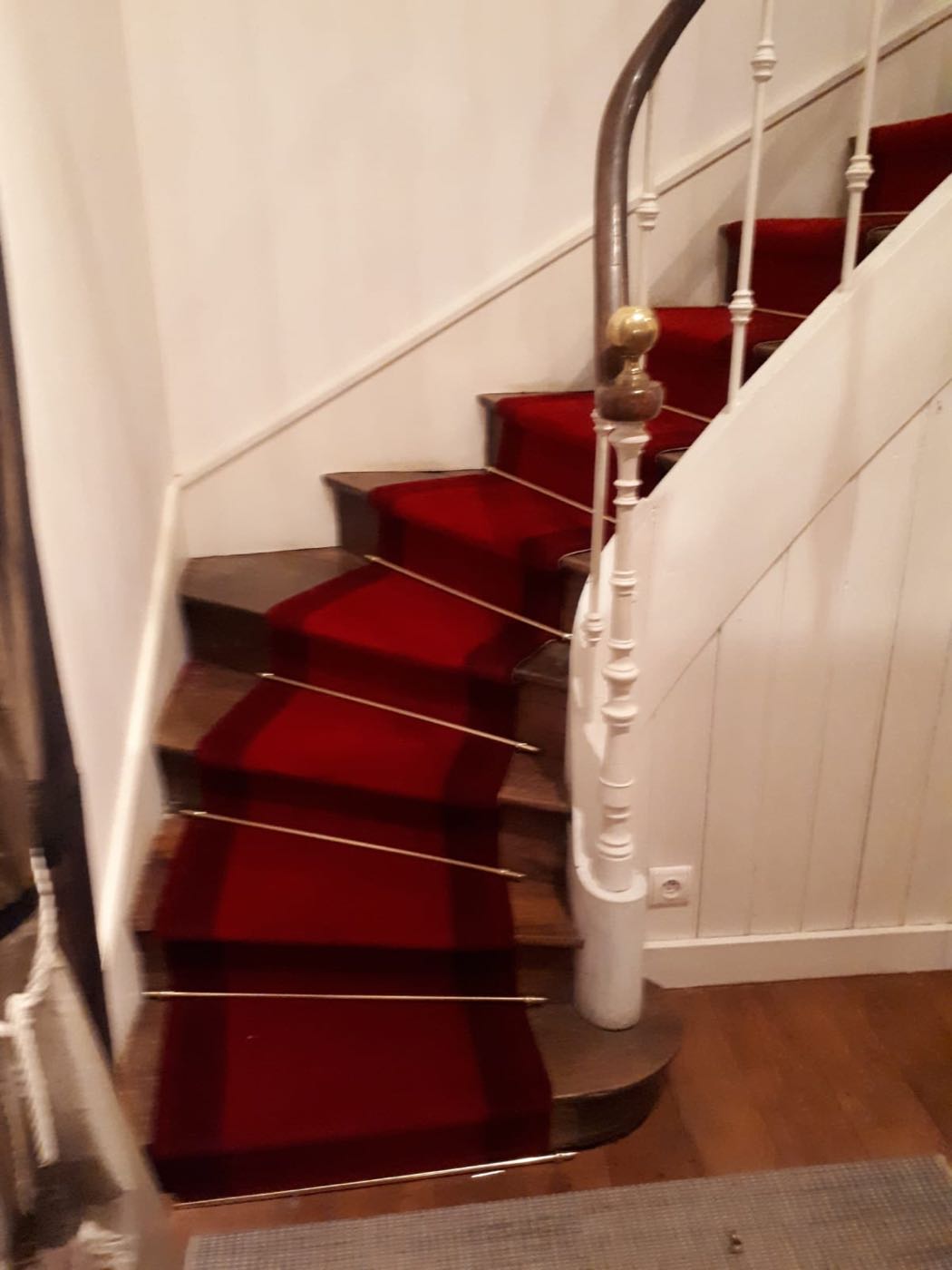 Escalier tournant habillé d'un tapis rouge